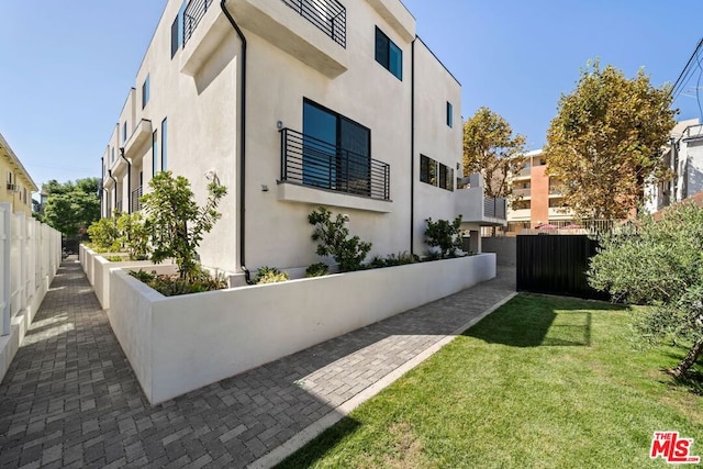 view of side of home featuring a yard