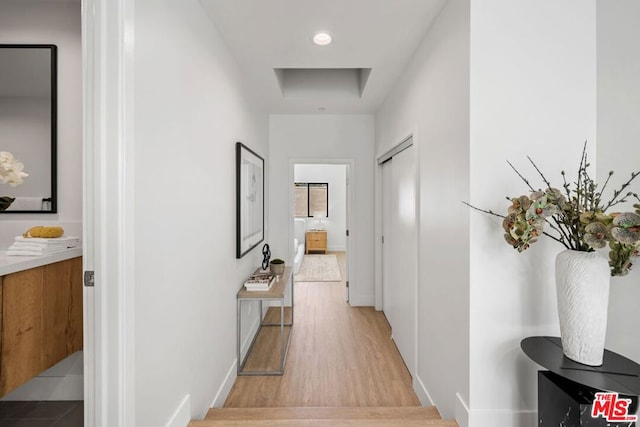 corridor with light hardwood / wood-style floors