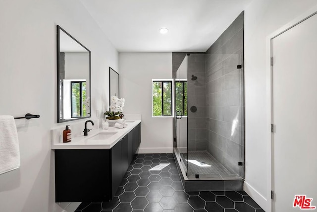 bathroom with vanity, a shower with door, tile patterned floors, and plenty of natural light