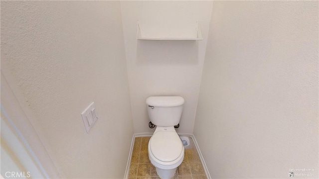 bathroom with tile patterned floors and toilet