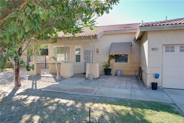 rear view of property with a garage