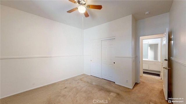 interior space with light colored carpet and ceiling fan