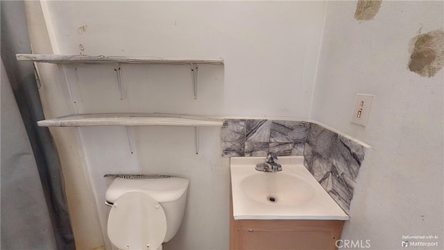 bathroom featuring vanity and toilet