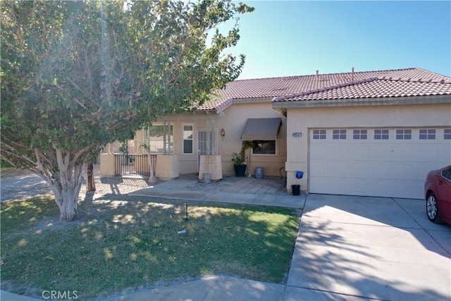 view of front of home featuring a garage and a front lawn