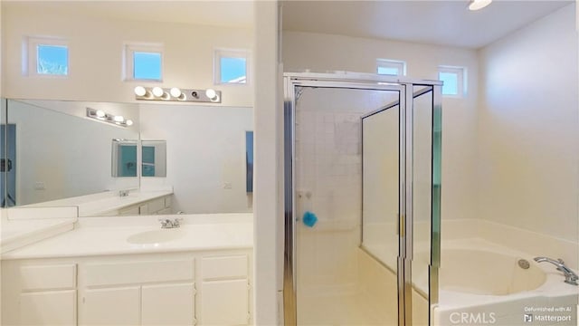 bathroom featuring plus walk in shower and vanity