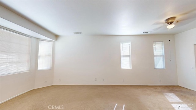 spare room featuring ceiling fan and light carpet