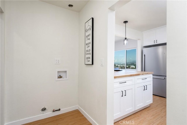 laundry room with washer hookup, hookup for a gas dryer, and light hardwood / wood-style flooring