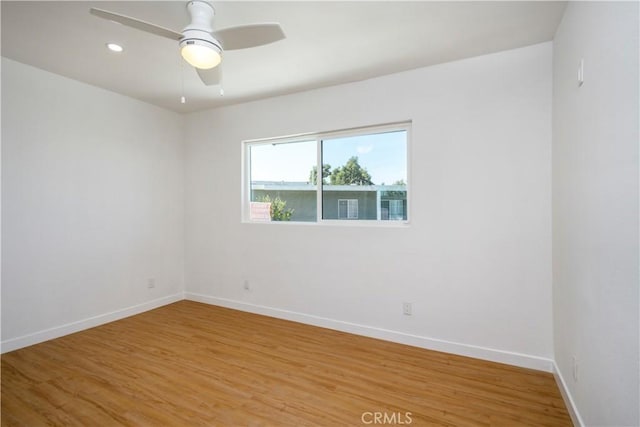 spare room featuring ceiling fan and hardwood / wood-style floors