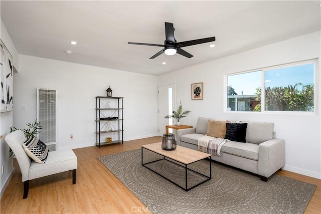 living room featuring hardwood / wood-style flooring and ceiling fan