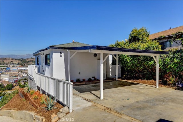 exterior space featuring a mountain view and a carport