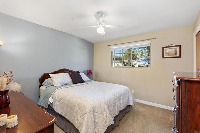 bedroom with ceiling fan and light colored carpet