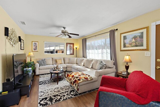 living room featuring hardwood / wood-style floors, plenty of natural light, and ceiling fan