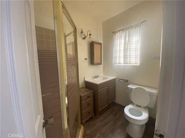 bathroom with vanity, toilet, and hardwood / wood-style floors