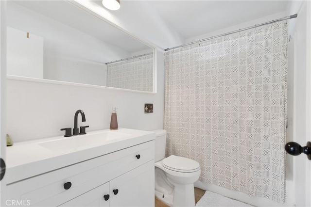 bathroom with vanity, a shower with shower curtain, and toilet