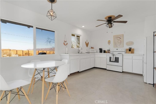 kitchen featuring white cabinets, pendant lighting, white appliances, and ceiling fan