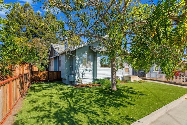 view of property exterior with a lawn