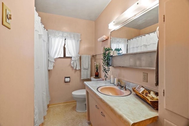 bathroom featuring toilet and vanity