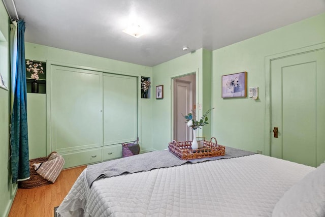 bedroom with hardwood / wood-style flooring