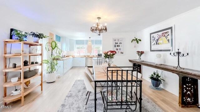 dining room featuring an inviting chandelier and light wood-type flooring