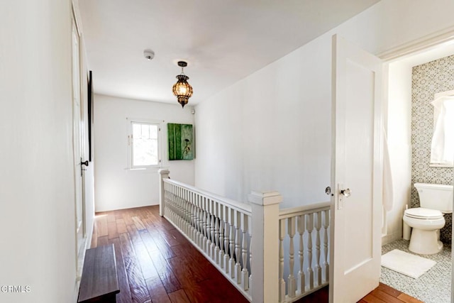 hallway featuring wood-type flooring and an upstairs landing