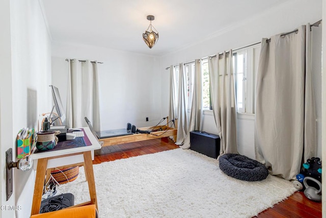 interior space featuring crown molding and wood finished floors