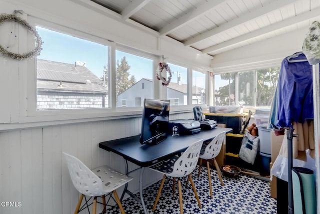sunroom with wooden walls, tile patterned floors, and beam ceiling