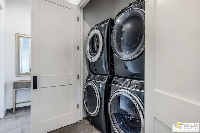 clothes washing area with stacked washing maching and dryer