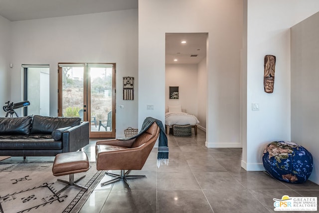 living room featuring a high ceiling and french doors