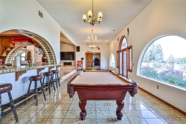 playroom featuring light tile patterned floors, an inviting chandelier, and pool table