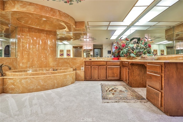 bathroom with vanity, wood walls, and a bath