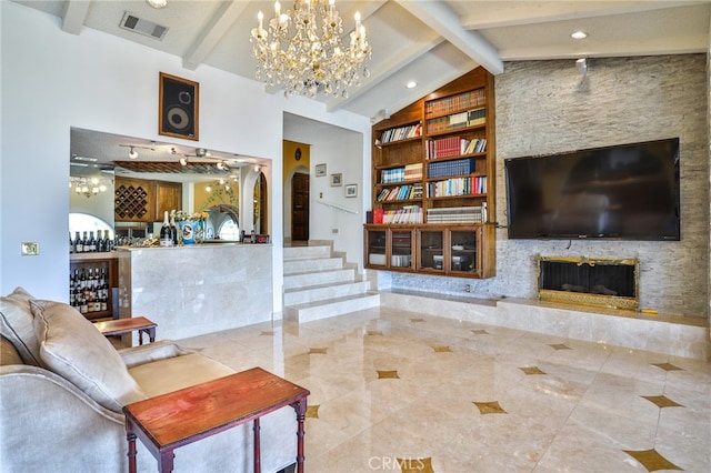 living room featuring bar, built in features, lofted ceiling with beams, and a chandelier