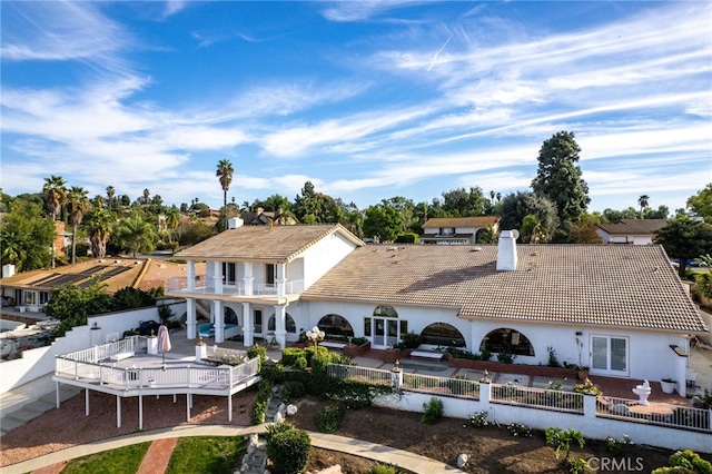 back of house with a balcony and a patio