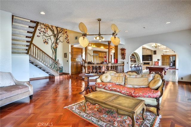 living room featuring parquet flooring, billiards, and a textured ceiling