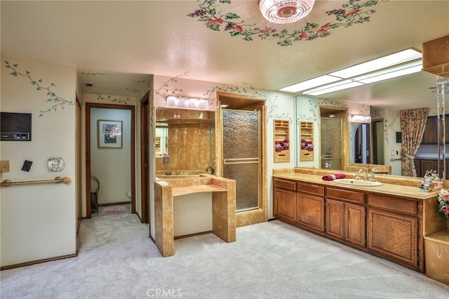 bathroom featuring a shower with shower door and vanity