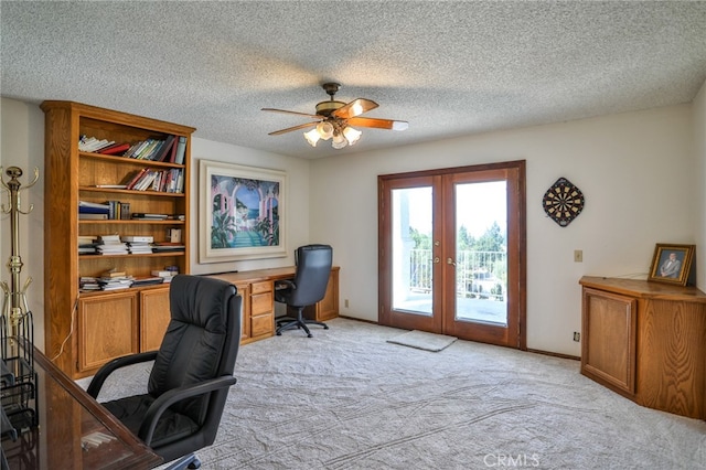 office with a textured ceiling, ceiling fan, light colored carpet, and french doors