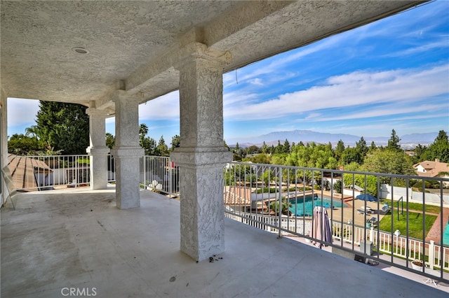 view of patio with a mountain view and a fenced in pool