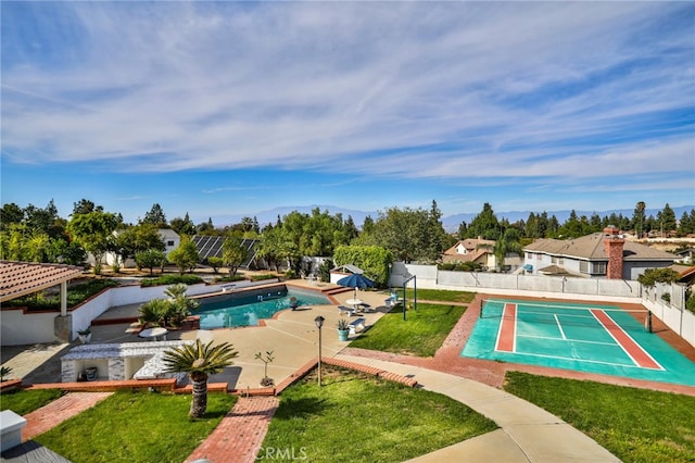 view of swimming pool with a lawn