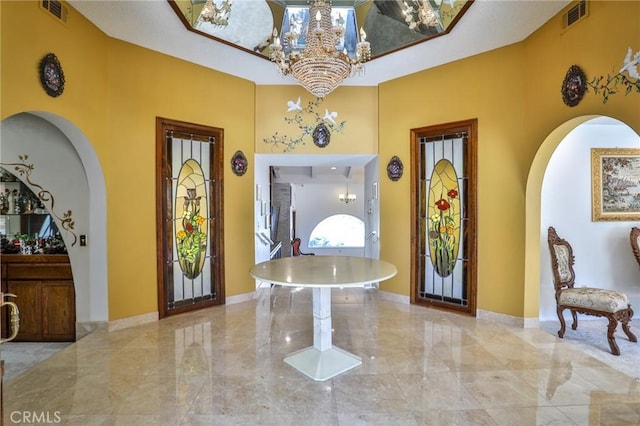 entryway with a chandelier