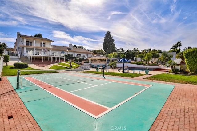 surrounding community featuring tennis court and a pergola