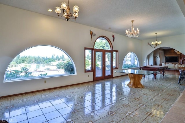 foyer entrance featuring a textured ceiling, tile patterned floors, and billiards