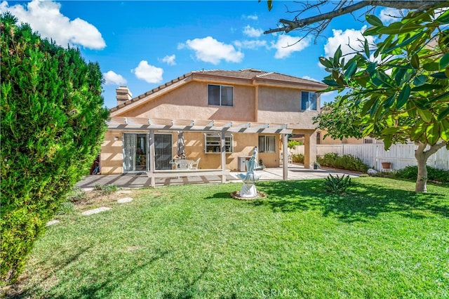 rear view of property featuring a pergola, a patio area, and a yard