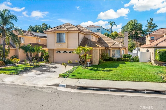 view of front of property featuring a front lawn and a garage