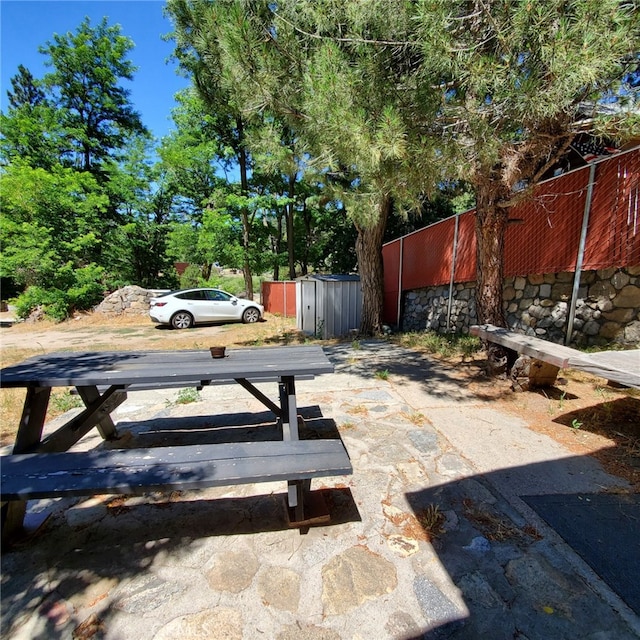 view of patio / terrace featuring a shed