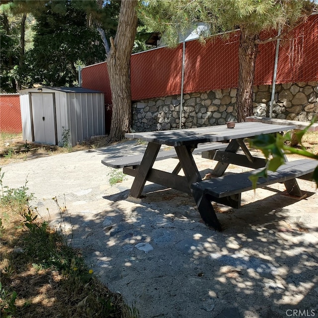 view of patio with a storage shed