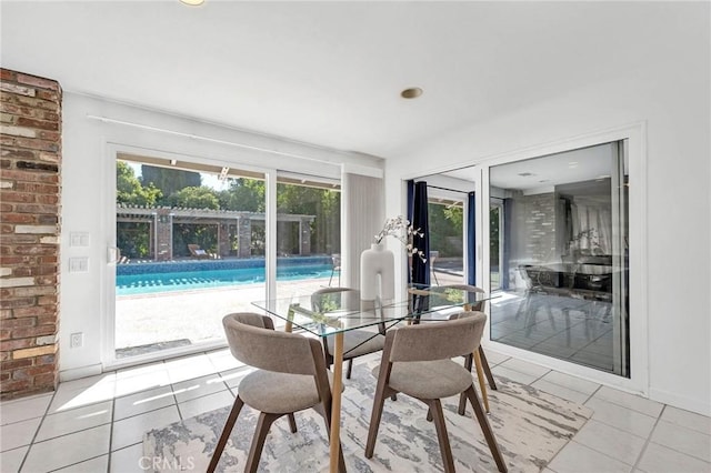 dining room with a healthy amount of sunlight and light tile patterned floors