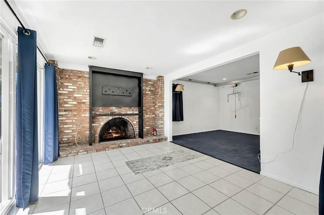 unfurnished living room featuring a fireplace and light tile patterned floors