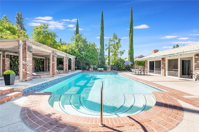 view of pool with a pergola and a patio