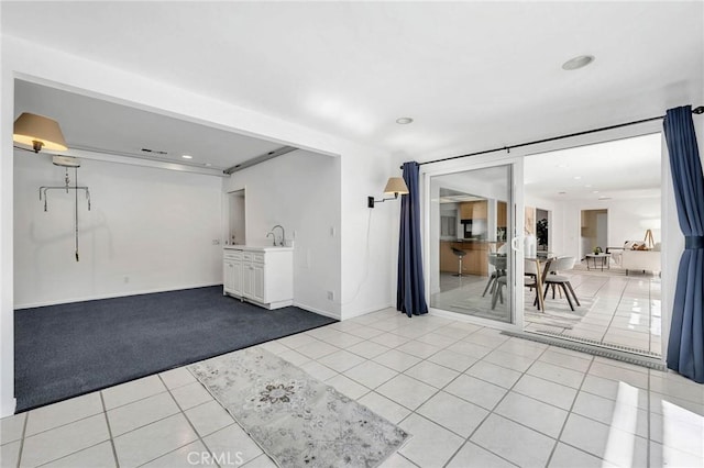 interior space with sink and light tile patterned floors