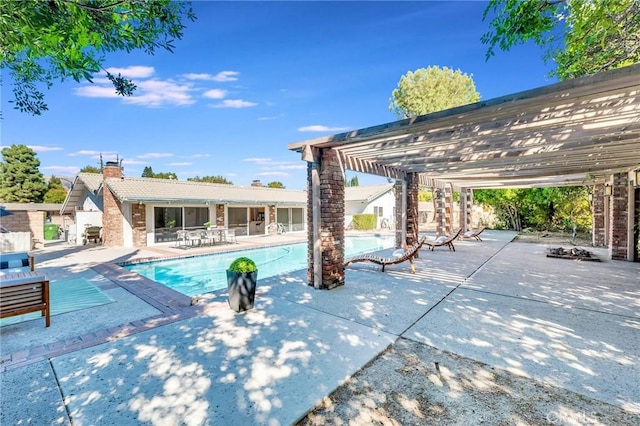 view of swimming pool featuring a pergola and a patio