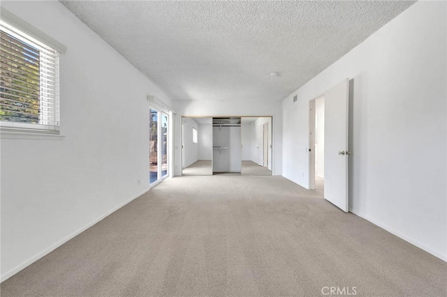 interior space with a textured ceiling and a healthy amount of sunlight